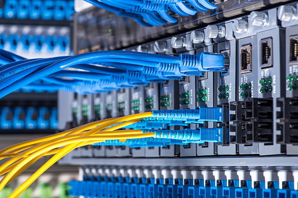 fiber optic cables and utp network cables connected hub ports.