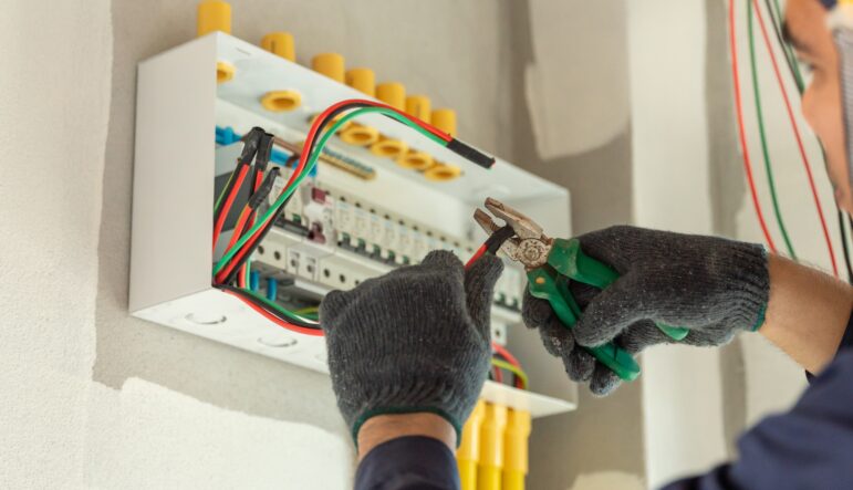 an,electrician,inspects,the,electrical,wiring,in,an,new,home,